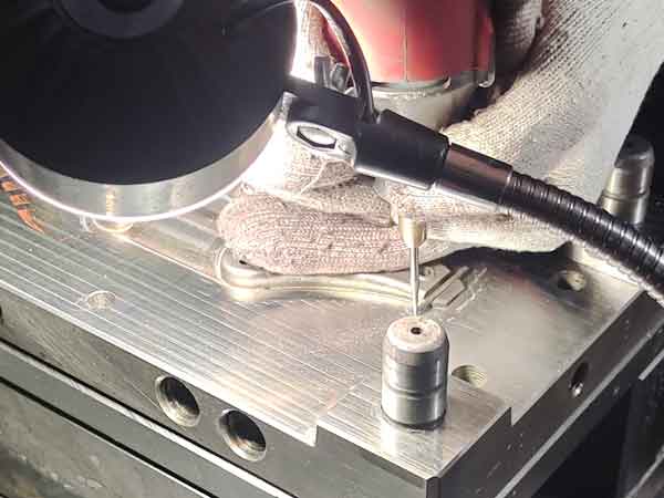 Use a rotary tool to remove excess material and adjust the size in mold manual fitting