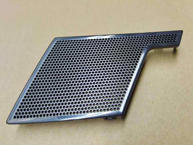 Front side of complex-shaped ABS plastic speaker cover with high-gloss finish and precise perforated holes
