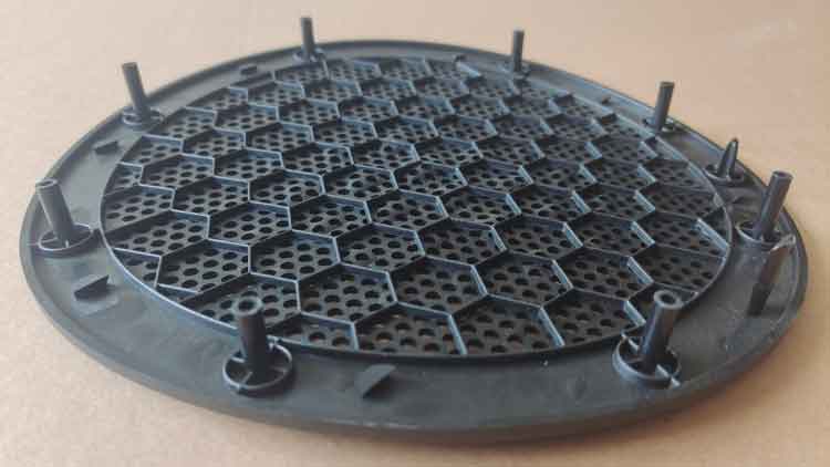 Back side of a round PP plastic speaker cover, showing the structural design without rounded edges
