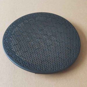Front side of a round plastic speaker cover made from PP, showing fine perforated holes with smooth edges