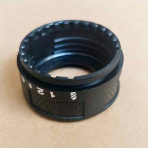 Close-up of the inner surface of a plastic adjustment knob, highlighting the intermittent threads designed for positioning alignment.