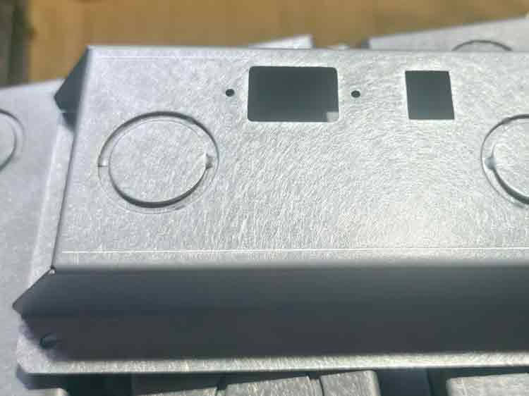 Close-up showing the polished surface of electro galvanized steel with a textured finish applied to conceal light scratches.