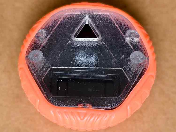Close-up view of a custom plastic toy showing the textured transparent cover, detailed molding pattern, and soft silicone edge.