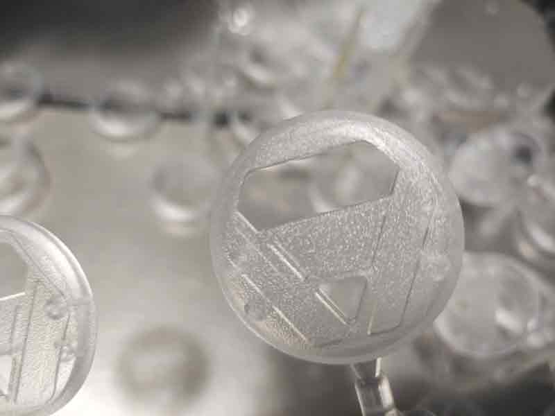 Close-up view of the custom plastic toy’s transparent cover showing the VDI 27–30 textured surface with a clear contrast between the textured and polished areas.